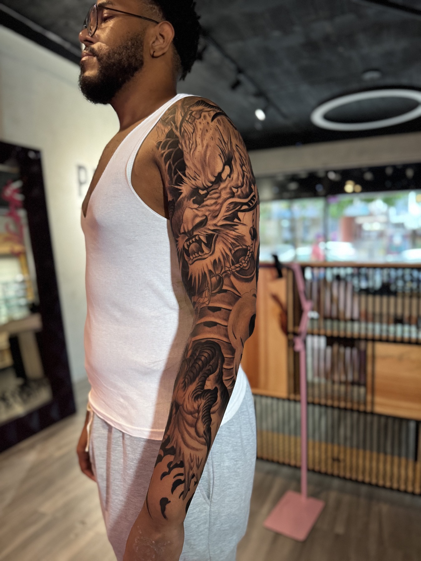 Black and grey dragon full sleeve tattoo by Mike Villamizar