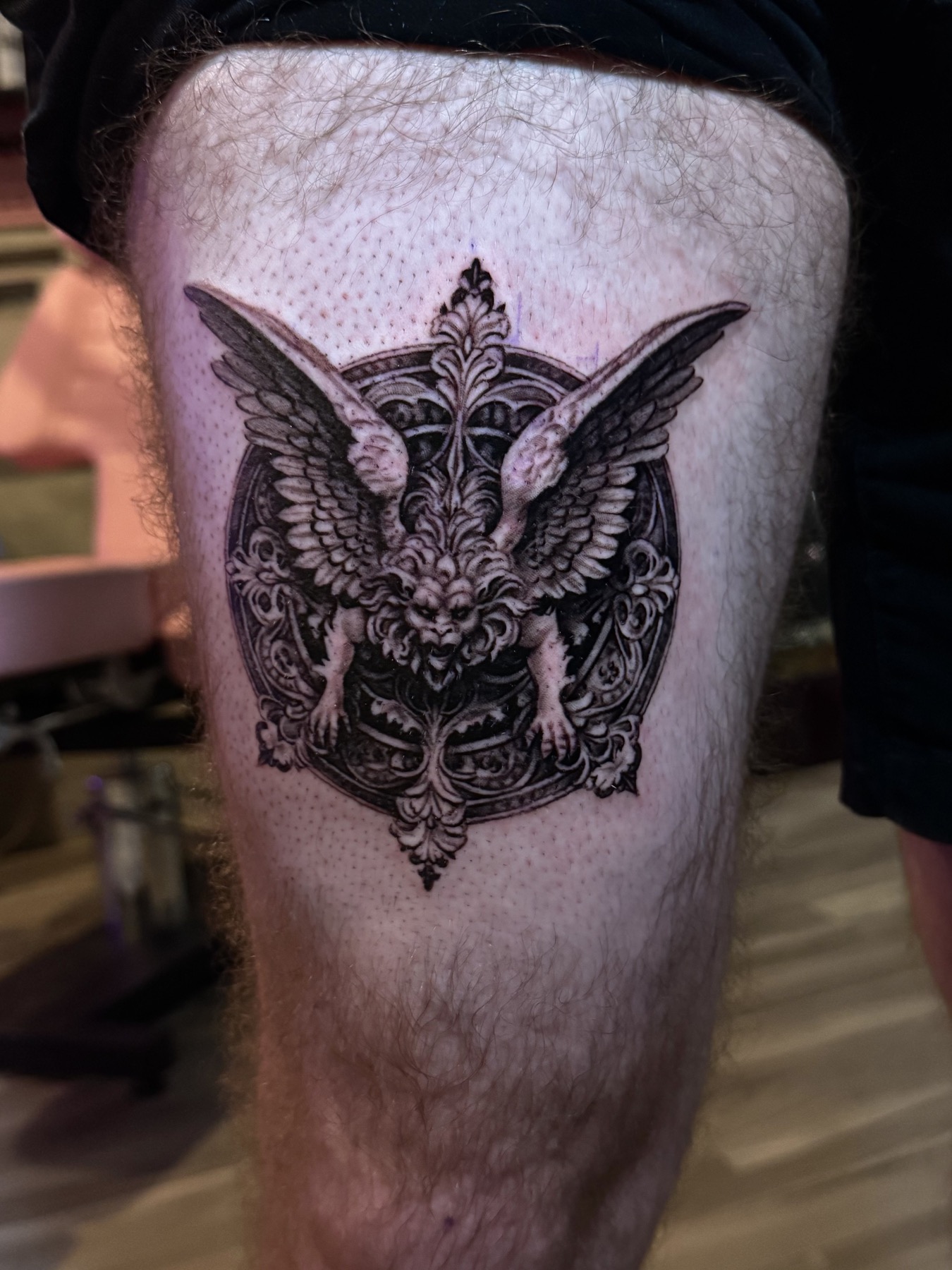 Detailed black and grey gargoyle tattoo by Mike Villamizar