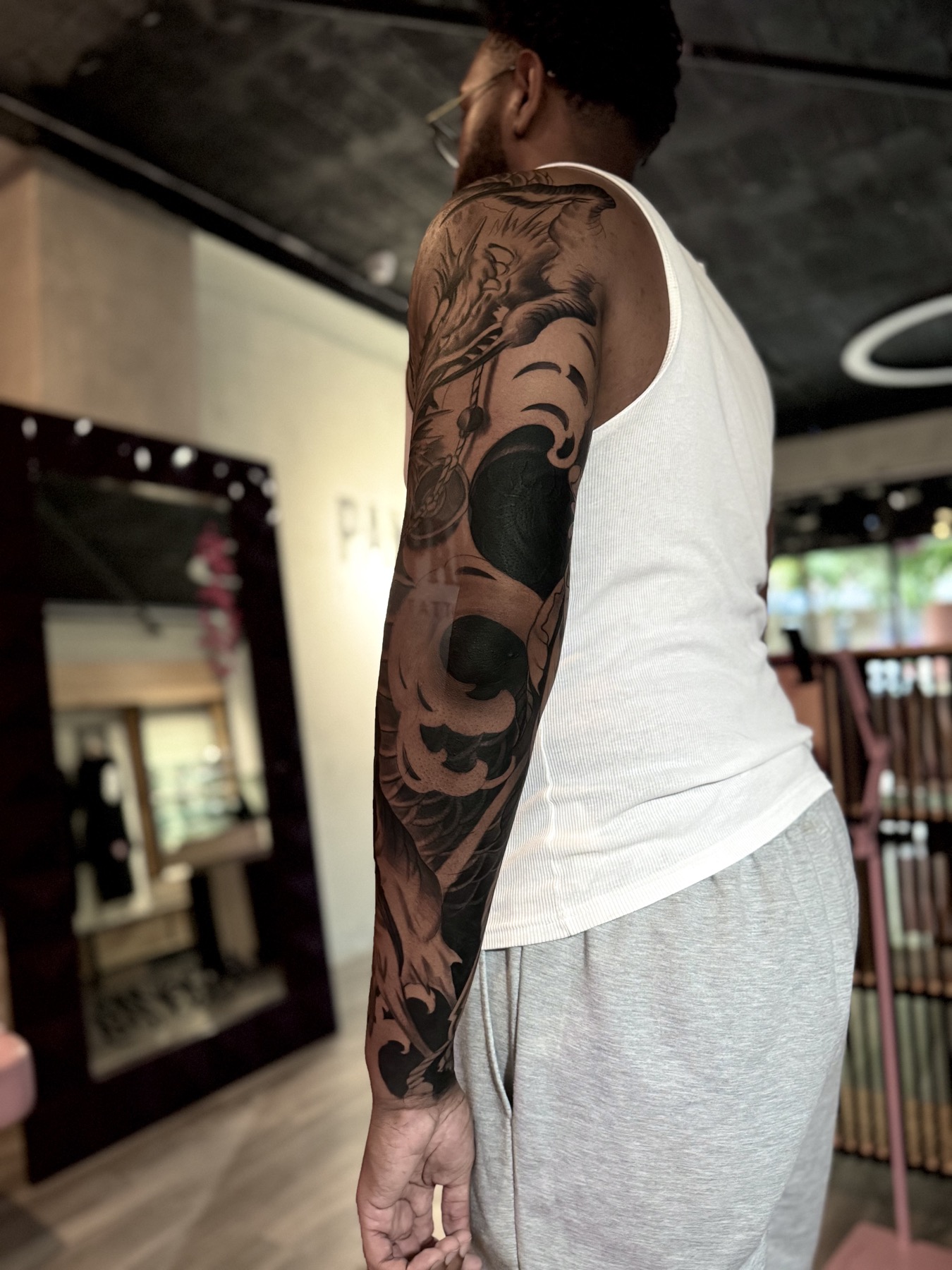 Back view of a black and grey dragon sleeve by Mike Villamizar