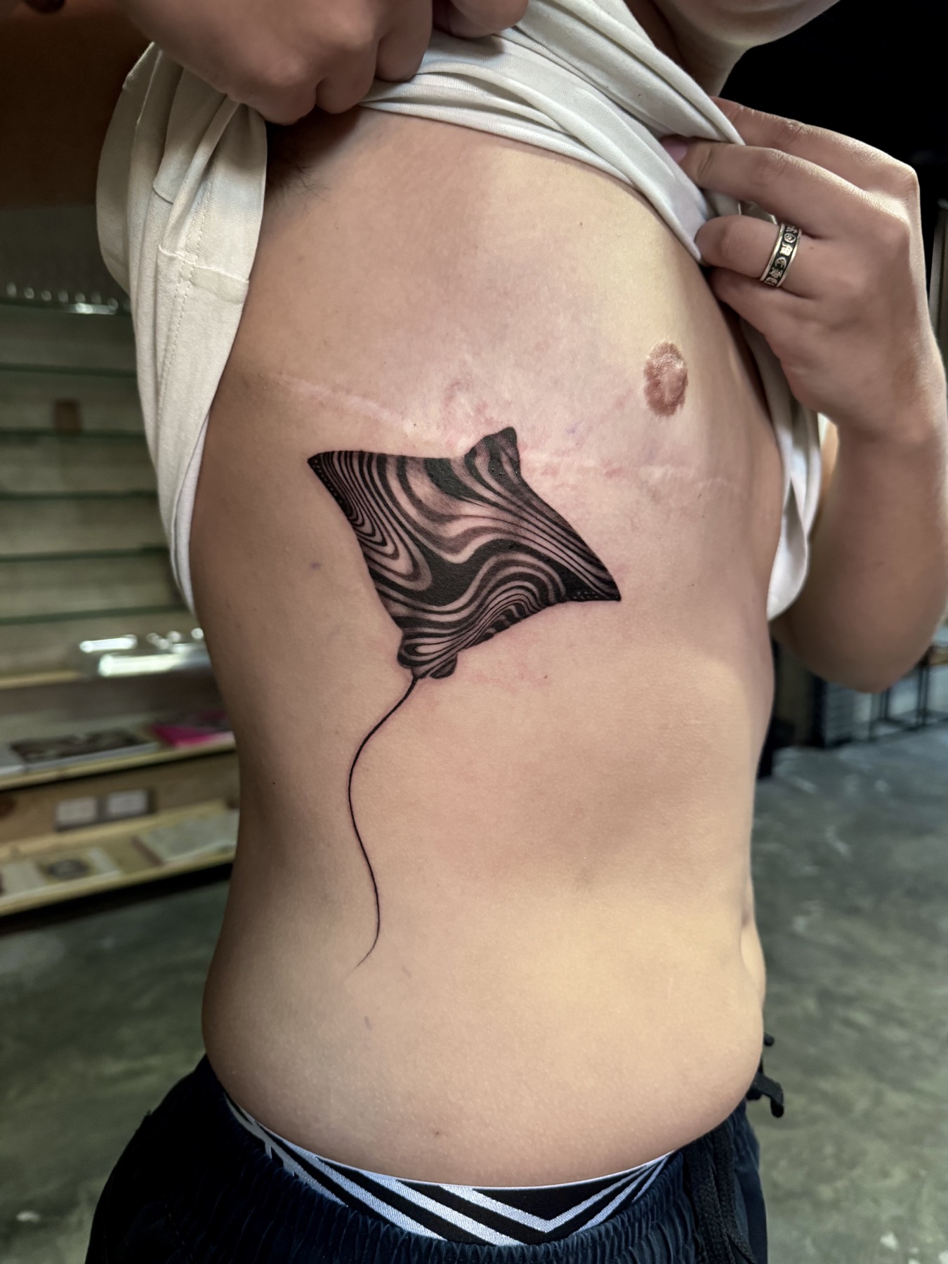 Graphic black ink manta ray tattoo by Mike Villamizar