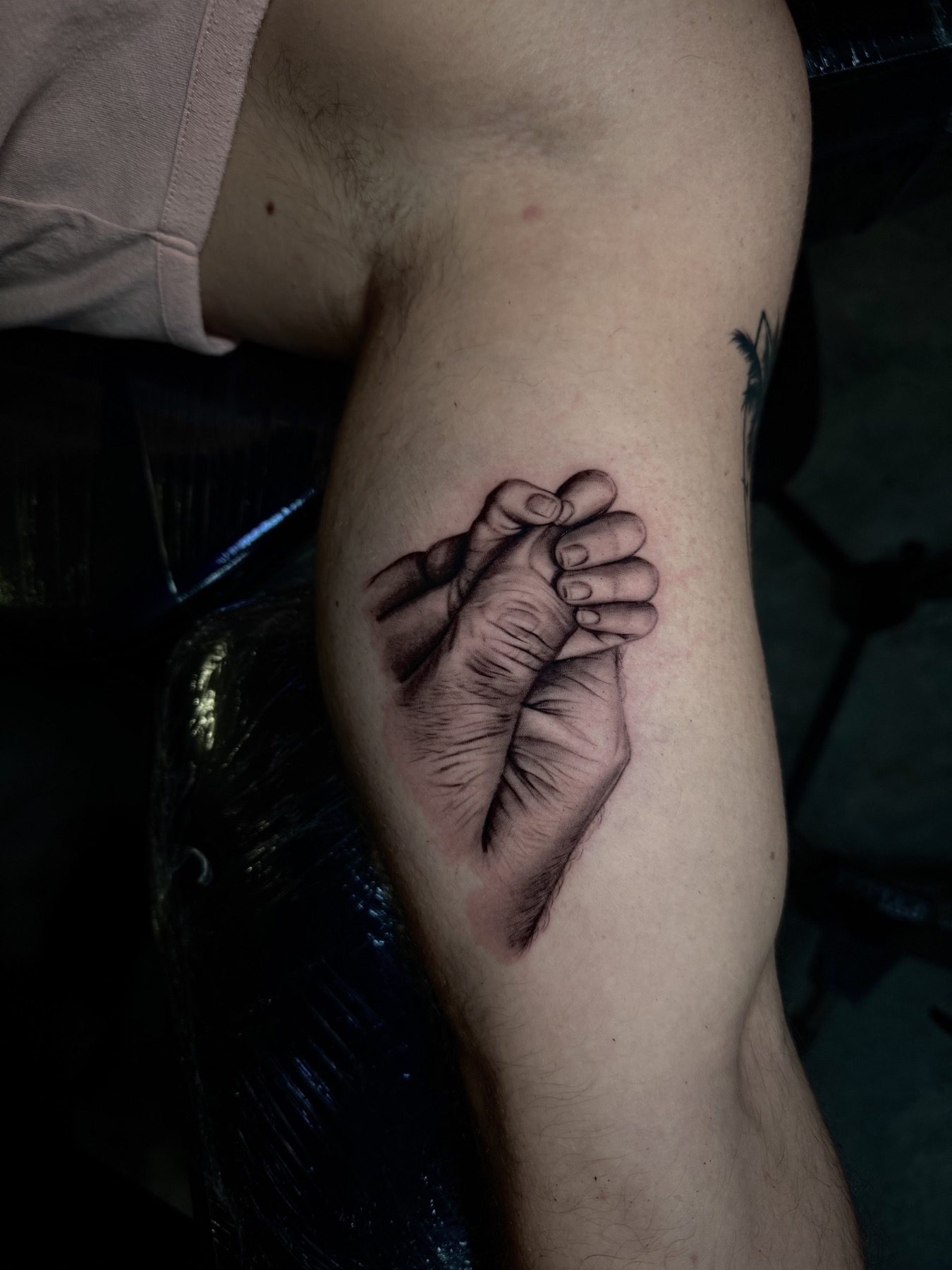 Small detailed black and grey hands tattoo by Mike Villamizar